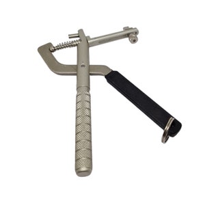 May include: A silver metal watch band tool with a black handle and a spring-loaded mechanism. The tool has a key ring attached to it.