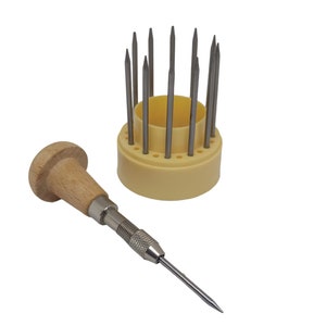 May include: A set of 12 metal tools with wooden handles, used for jewellery making. The tools are arranged in a yellow plastic holder with holes for each tool.