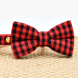 May include: Red and black plaid bow tie cat collar with a gold bell and a pearl charm.