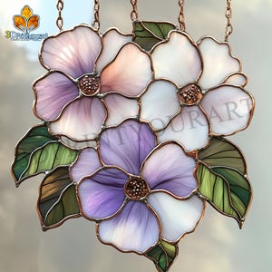 May include: A stained glass window hanging with three purple, white, and pink flowers with green leaves. The flowers are outlined in copper.