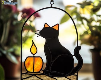 May include: A stained glass window hanging features a black cat sitting next to a lit candle. The cat is looking to the left and the candle is orange and yellow.