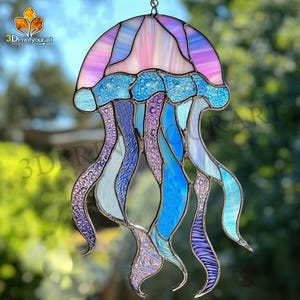 Könnte beinhalten: Ein Buntglas-Medusen-Sonnenfänger in Rosa, Blau und Lila. Die Qualle hat eine glockenförmige Oberseite und lange, fließende Tentakel.