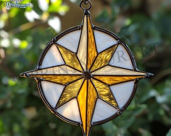 May include: A stained glass compass ornament with a gold and white star design. The ornament is hanging from a black string.