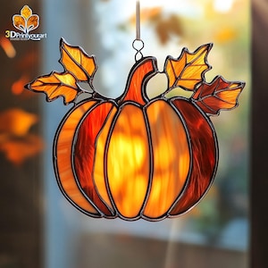 May include: A stained glass pumpkin with orange and brown glass pieces. The pumpkin has a stem and leaves. The leaves are made of yellow and green glass. The pumpkin is hanging from a string.