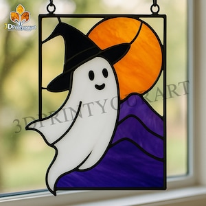 May include: Stained glass Halloween decoration showing a friendly ghost in a black witch hat. The ghost is set against an orange sun and purple mountains. The artwork is framed in black and includes the text "3DPrintyourart".