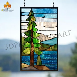 May include: Stained glass panel depicting a landscape with a green tree, blue water, and mountains. The panel is framed in black and suspended by a chain. The text "3DPrintyourart" is visible.