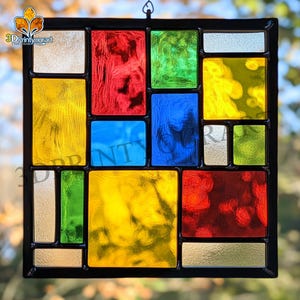 May include: A stained glass window with a geometric design featuring squares and rectangles in red, yellow, blue, green, and silver.