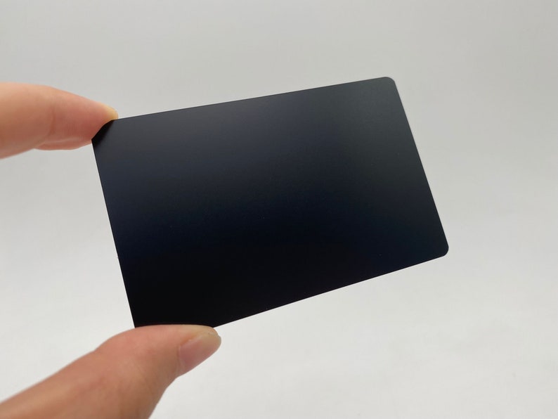 May include: A black plastic card with a smooth, matte finish.