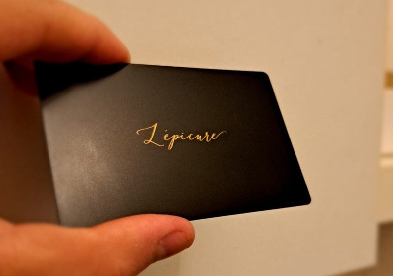 May include: A black card with gold lettering that reads 'Lipicure'.