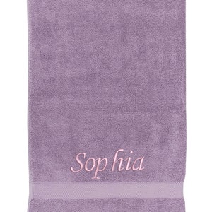 May include: A lavender-colored towel with the name "Sophia" embroidered in pink.