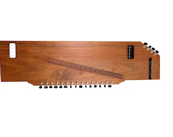 May include: A wooden zither string instrument with a rectangular body, featuring a diagonal bridge, multiple metal tuning pegs along the bottom edge, and a series of thin strings stretched across the top surface with two sound holes.
