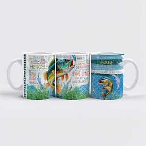 May include: Three white ceramic mugs with colorful fish designs. One mug features a fish leaping from water, another has a fish illustration, and the third has a fish with text in a foreign language. The mugs are for fishing enthusiasts.
