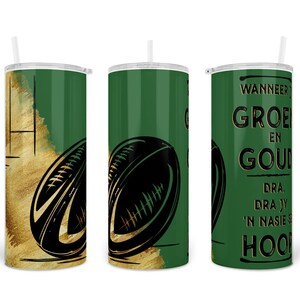 Pu&ograve; includere: Un set di tre bicchieri isolati verdi e oro con cannucce bianche. Ogni bicchiere presenta un design a palla da rugby nera. Un bicchiere ha testo nero. Il design include pennellate dorate e strisce verdi verticali.
