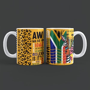 Puede incluir: Dos tazas de cerámica blanca con diseños coloridos. Una taza presenta un estampado de leopardo amarillo y texto. La otra taza muestra una ilustración de cebra con la bandera sudafricana y la frase "No stress SHAP".