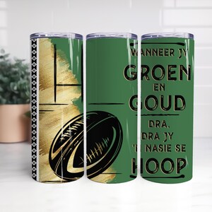 May include: A set of three stainless steel tumblers. The tumblers feature a green and gold design with a rugby ball graphic. One tumbler has text in black. The tumblers are designed for cold beverages.