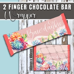 May include: A pink chocolate bar wrapper with the text "2 Finger Chocolate Bar Wrapper" and "Baie dankie". The wrapper features a colorful floral design with succulents and a coral-colored edge. The dimensions are 140mm x 100mm.