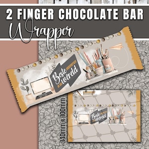 May include: A chocolate bar wrapper with the text "2 Finger Chocolate Bar Wrapper" in a decorative font. The wrapper features illustrations of pencils, a computer, and the text "Beste onderwyser in die wêreld". The wrapper is 140mm x 100mm.