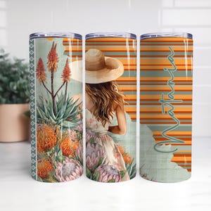 May include: Three stainless steel insulated tumblers with a botanical design. The tumblers feature aloe vera plants and a woman wearing a hat. One tumbler has the name "Valtana" in a script font.