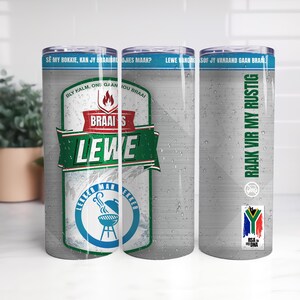 May include: A stainless steel tumbler with a blue rim and lid. The tumbler features text and graphics related to braai, including the words "Braais Lewe" and a South African flag. The design includes a grill graphic.