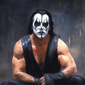 May include: A man with long black hair and a black and white face paint design sits with his arms crossed. He is wearing a black sleeveless shirt and black trousers.