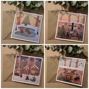 May include: Set of four illustrated Christmas cards featuring badgers in a wintery forest setting. The cards depict badgers ice skating, enjoying a Christmas meal, singing carols, and relaxing by a fireplace.