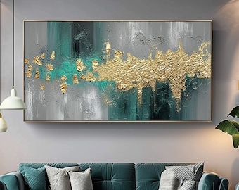 Peut inclure: Tableau abstrait aux tons or, turquoise et gris. L'œuvre présente des accents dorés texturés et un cadre rectangulaire doré. La toile est non encadrée et est décrite comme 100% originale.