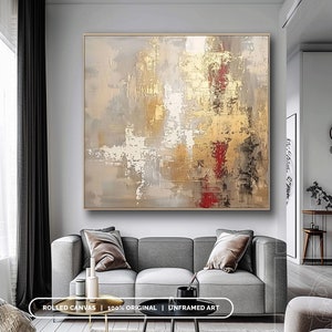 a living room with a couch and a painting on the wall