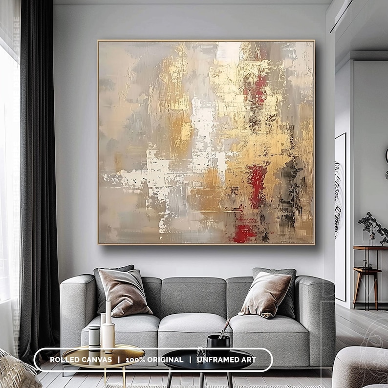 a living room with a couch and a painting on the wall