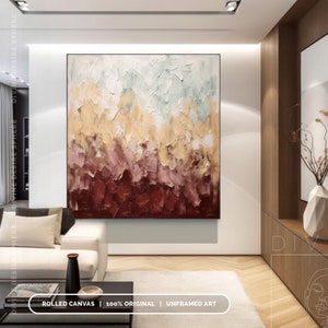 May include: Large abstract painting with a textured surface. The artwork features a palette of colors including deep red, burgundy, tan, and pale green. The painting is displayed in a modern living room setting.