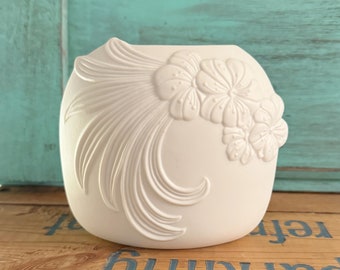 May include: White ceramic vase with an embossed floral design. The vase has a rounded shape and a smooth, white finish.