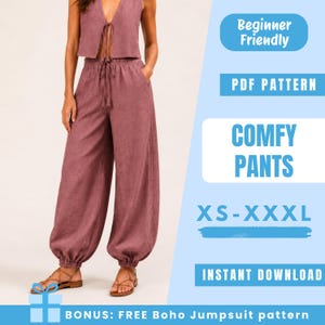 May include: A mauve-colored two-piece outfit, consisting of a sleeveless top with a tie closure and wide-leg pants with a drawstring waist. The image includes the text "COMFY PANTS" and "XS-XXXL". The outfit is shown on a person wearing sandals.