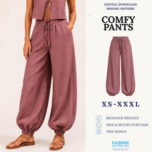 May include: A digital download sewing pattern for comfy pants in a dusty rose color. The pants feature a high-waisted design with an elastic waistband, a drawstring tie, and gathered cuffs at the ankles. The pattern is available in sizes XS-XXXL.