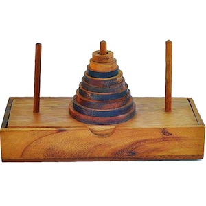 May include: A wooden puzzle box with a pyramid-shaped stack of rings inside. The box is made of light brown wood and has a sliding lid. The rings are made of dark wood and have a natural finish.