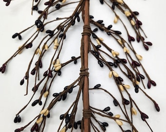 May include: A brown twig with multiple branches, each with small clusters of black, cream, and burgundy berries. The twig is wrapped with brown twine at intervals.