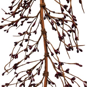 May include: A close-up of a decorative stem with brown branches and dark red berry-like accents. The central stem is wrapped with twine, and the branches extend outwards, creating a natural, organic aesthetic. The berries are glossy.