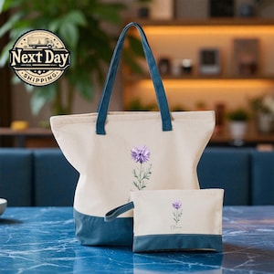 A beige tote bag with a blue handle and a smaller white bag with a purple flower design are placed on a blue marble countertop.