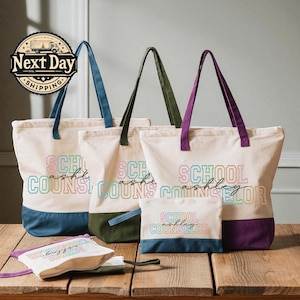 May include: Cream-colored tote bags with colorful text that reads "School Counselor" and a name. The bags have colored handles and a colored bottom panel. A matching small pouch is also visible.