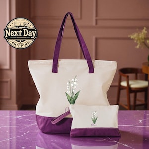 A large white tote bag with purple accents and a smaller white bag with a purple trim, both featuring a lily of the valley design, are displayed on a purple marble countertop.