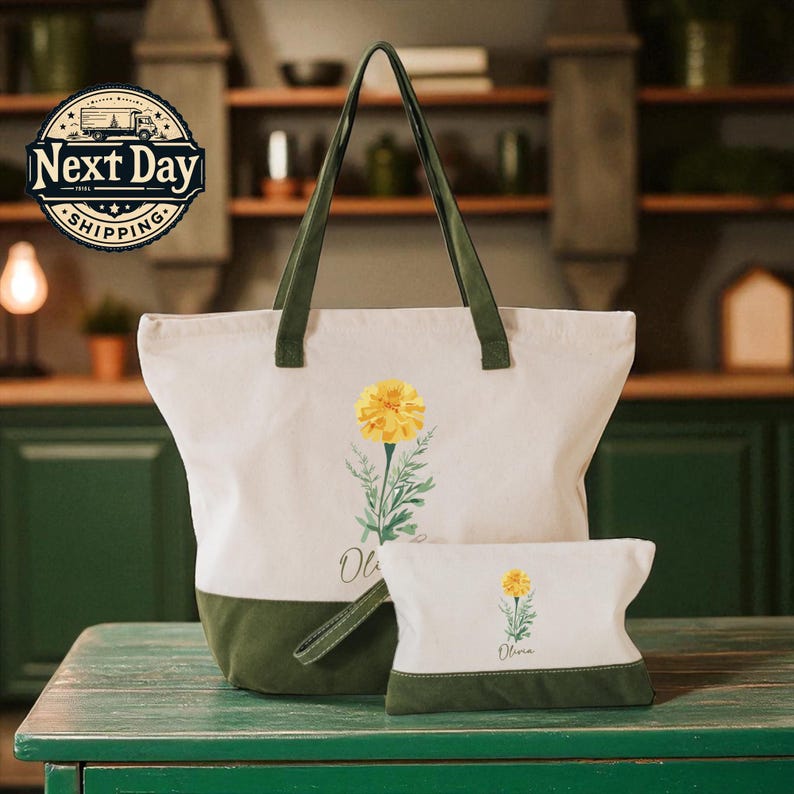 A large white tote bag with a green trim and a smaller white bag with a yellow flower design are displayed on a green wooden table.