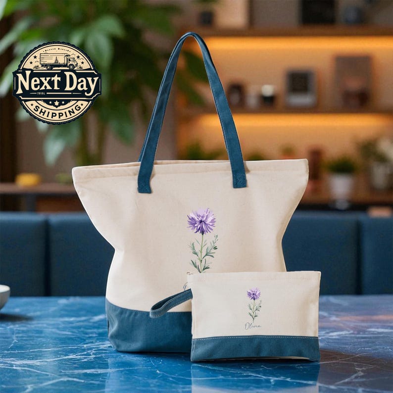 A beige tote bag with a blue handle and a smaller white bag with a purple flower design are placed on a blue marble countertop.