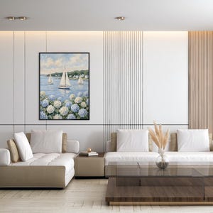 May include: A living room with a modern design. A framed painting of sailboats on the water hangs above a beige sectional sofa. A glass coffee table and a vase with dried plants complete the decor.