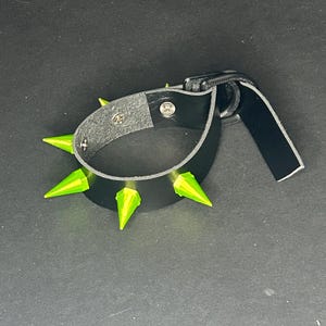 Bracelet with neon green spikes.