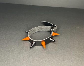 Pulsera con pinchos naranja y negra