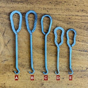May include: Five silver-colored metal tools labeled A through E, each featuring a looped handle and a hook at the opposite end. The tools vary in length and handle texture, with some handles showing a cross-hatched pattern and others being smooth.