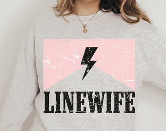 May include: A gray sweatshirt with a pink and white graphic of a lightning bolt and the text "LINEWIFE".