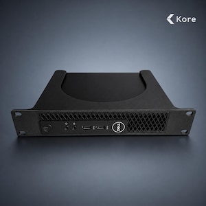 May include: A black Dell rack-mount computer chassis featuring a front-facing power button, two audio jacks, two USB ports, and a ventilation grille. The unit includes mounting ears on both sides and displays the Kore logo in the top right corner.