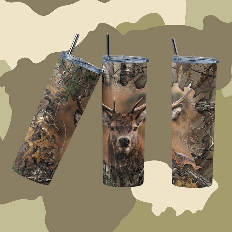 May include: Three stainless steel tumblers with lids and straws. The tumblers are covered in a camouflage pattern with a deer head image on the center tumbler.