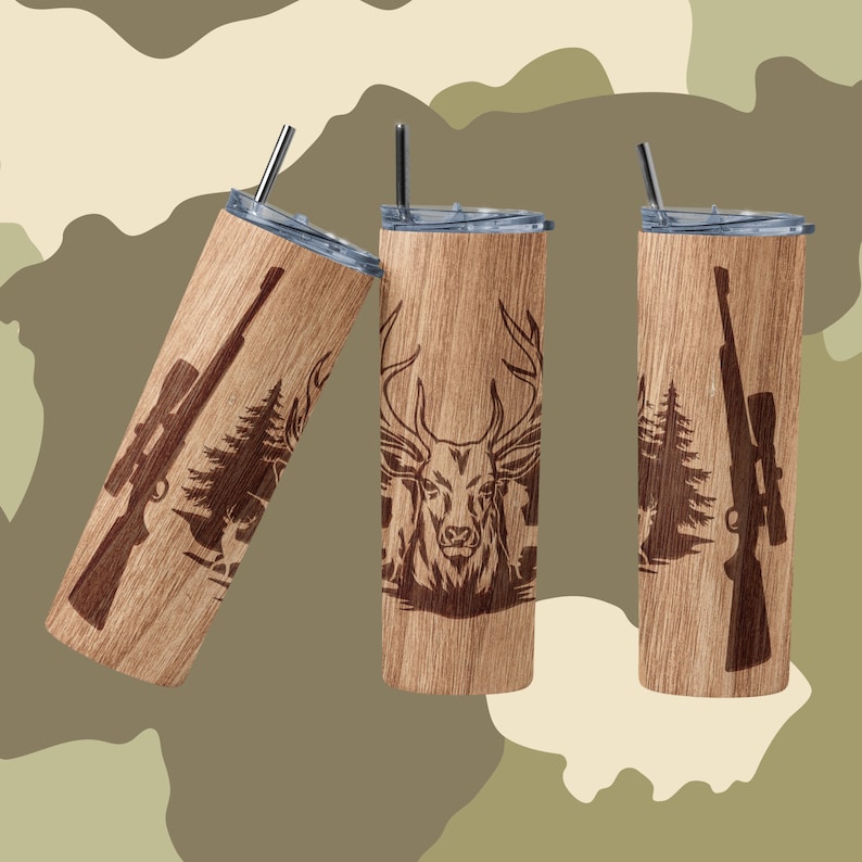 May include: Three stainless steel tumblers with a wood grain finish and laser-etched designs. One tumbler features a deer head, another a rifle, and the third a rifle and pine trees.