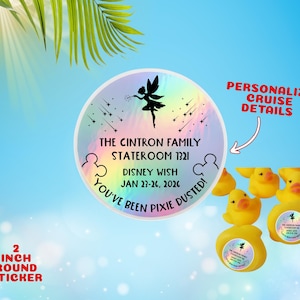May include: A 5 cm round sticker with text, "The Cintron Family, Stateroom 1321, Disney Wish, Jan 23-26, 2026, You've Been Pixie Dusted!" A black fairy silhouette and stars are on a rainbow background. Yellow rubber duckies are in the image.