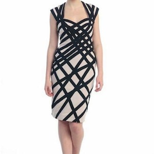 May include: A knee-length dress with a black and cream geometric pattern. The dress features a unique crisscross design on the bodice and skirt, with a scoop neckline and cap sleeves. The dress is worn with black heels.